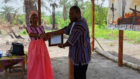 Rev. Willington Greene International Missions Director of Rhema Pentecostal Church certificating one of his members after a week long revival