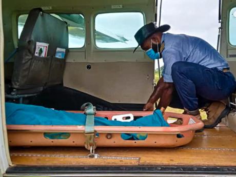 Pilot Joseph Tua securing the passenger