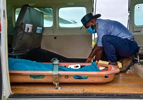 Pilot Joseph Tua securing the passenger