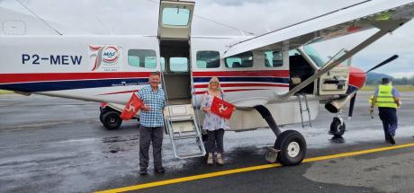 David Alison Dorricott holding flags from the Isle of Man prior to boarding P2-MEW