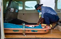 Pilot Joseph Tua securing the passenger